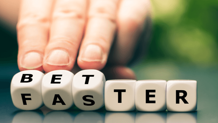 Hand arranging dice to change the spelling shown from "faster" to "better".